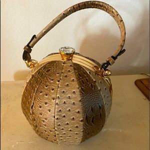 Tan vegan ostrich skin round purse .NWOT.